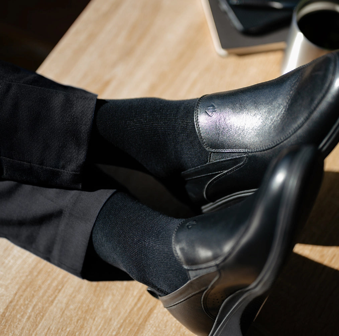close up detail photos of Amberjack Dress Socks in Obsidian paired with The Slip-On Obsidian and black dress pants
