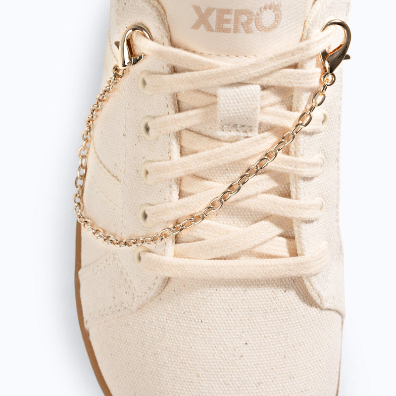 Xero Shoes a Close-up of a Gold Chain Shoe Charm in an Off-white Sneaker