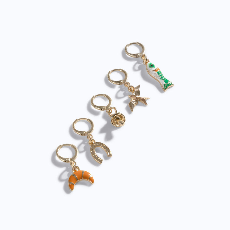 Xero Shoes 5-Piece 'Good Vibes' Charm Set arranged in a diagonal line