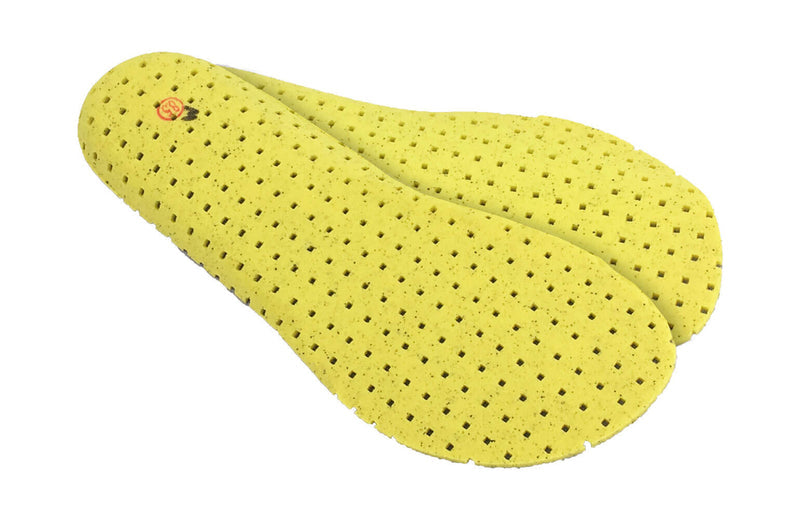 Xero Shoes Replacement Insoles Big Kids in Yellow Covered in Small Ventilation Holes and with Toe Facing Bottom Right