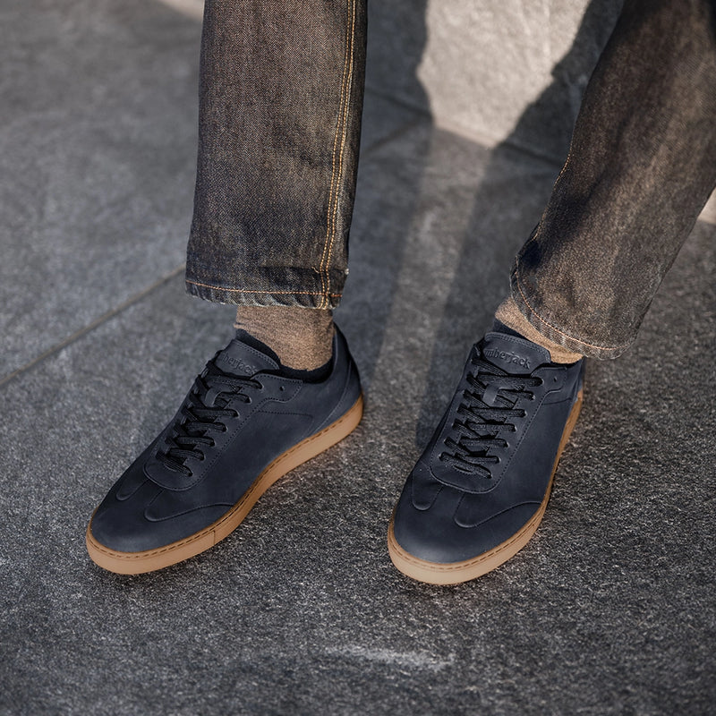 Model wearing dark jeans paired with Atlas Cobalt blue nubuck