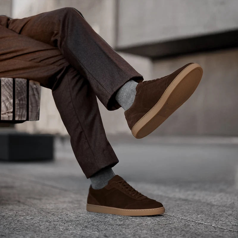 model wearing Atlas Walnut brown suede shoes with dark dress pants