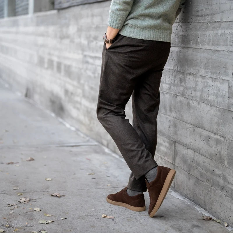 model wearing atlas walnut with dark dress pants and green sweater