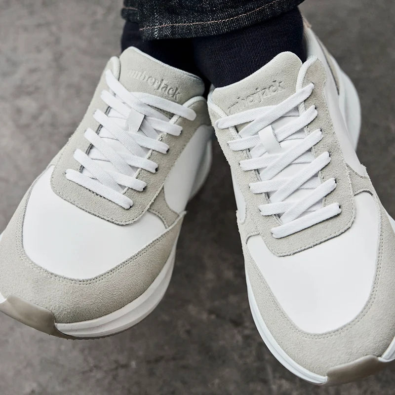 Model wearing The Axis in Ivory Suede by Amberjack with dark jeans close up photo