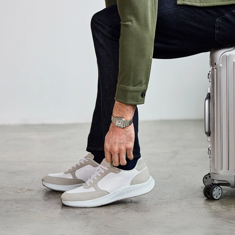 Model wearing The Axis in Ivory Suede by Amberjack with dark jeans and green shirt