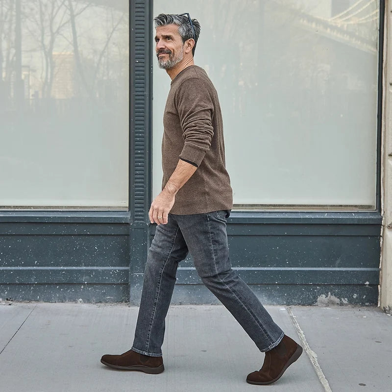 model walking wearing walnut chelsea and dark sweater