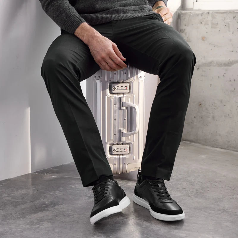 Model wearing The Court in Onyx leather & suede with black pants and gray sweater