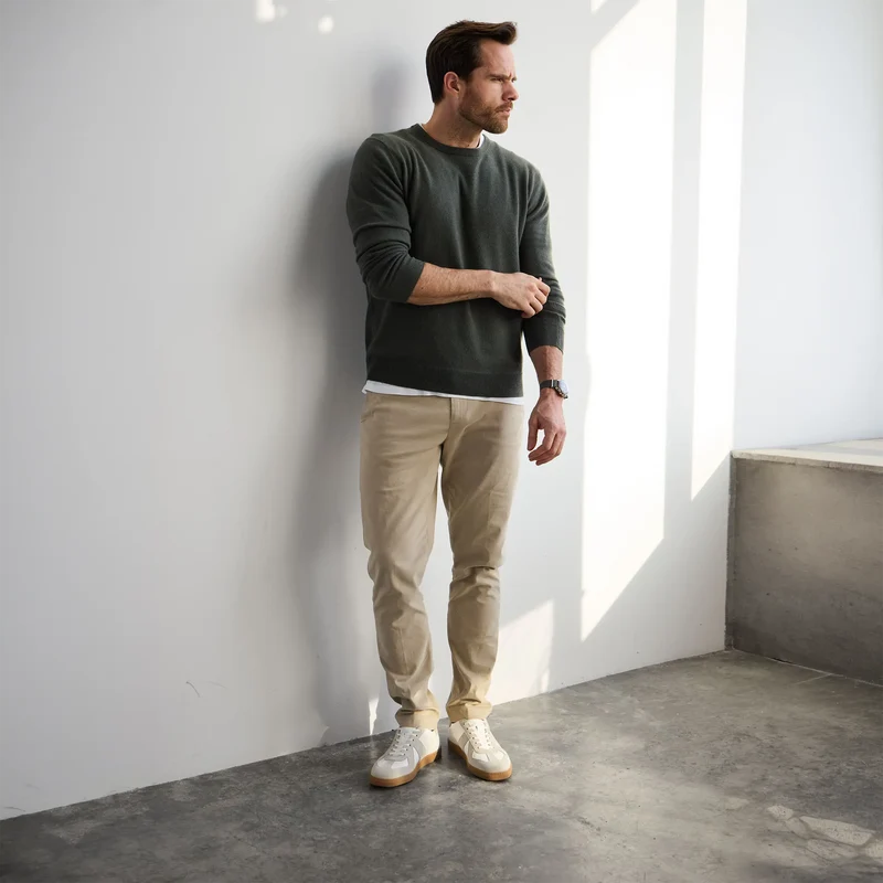 Model wearing The GAT in Ivory full grain leather & suede with khaki pants and green sweater