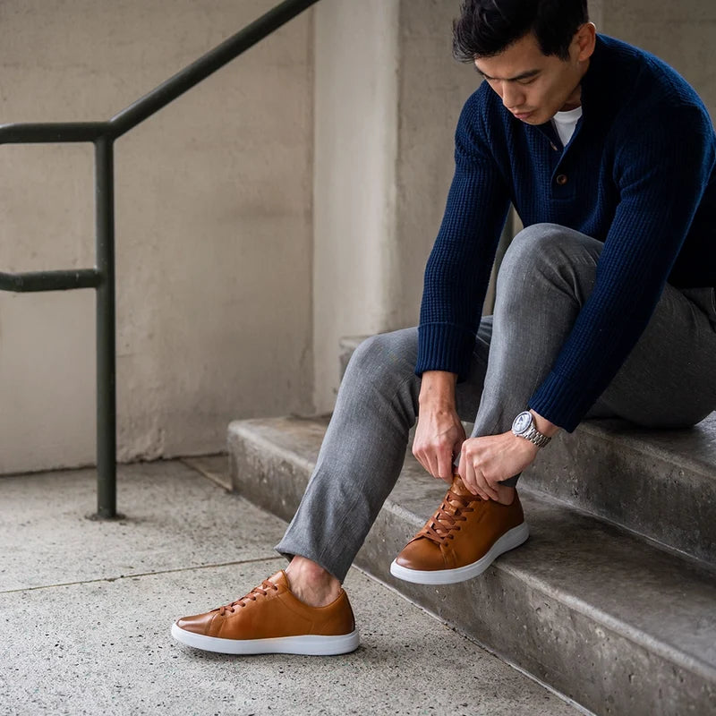 The Low-Top in Honey tan leather by Amberjack - worn by model with gray dress pants and blue sweater