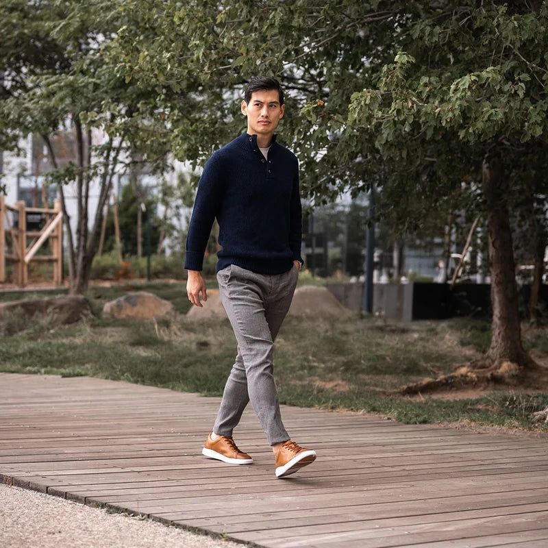 The Low-Top in Honey tan leather by Amberjack - worn by model with gray dress pants and blue sweater
