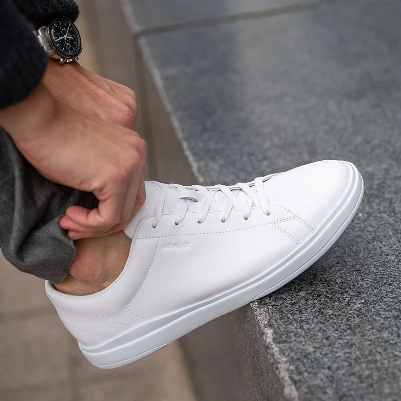 Model wearing The Low-Top in Ivory with gray dress pants