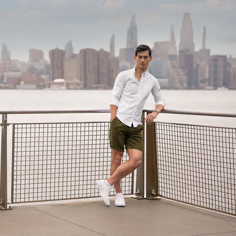 Model wearing The Low-Top in Ivory with green chino shorts & white button up top
