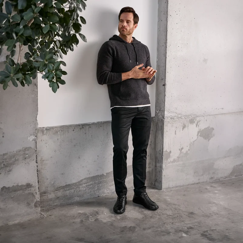 Model wearing The Low-Top in Obsidian pebbled leather with dark outfit