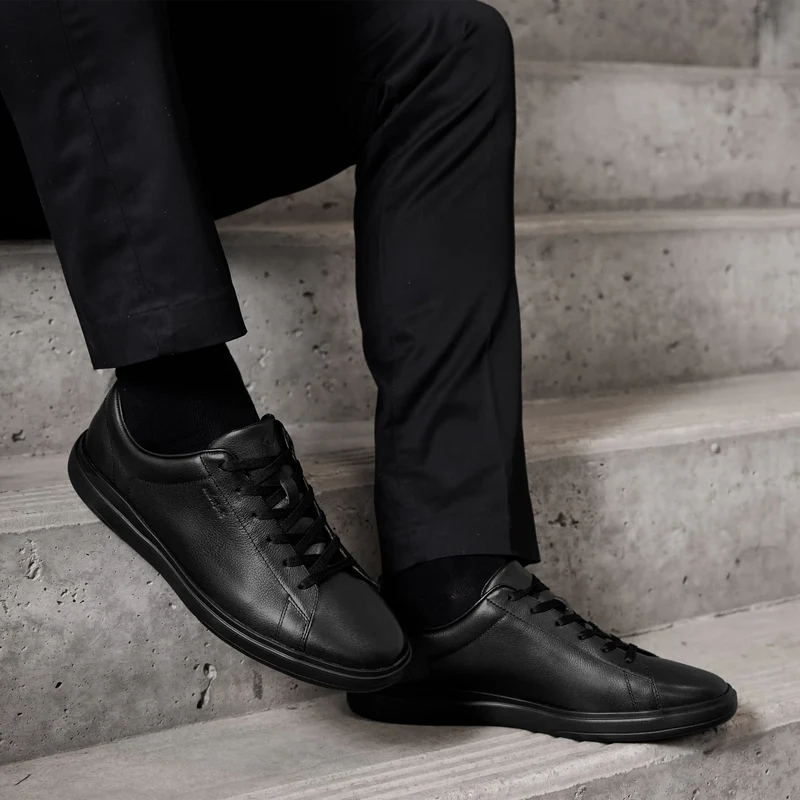 Model wearing The Low-Top in Obsidian pebbled leather with black pants