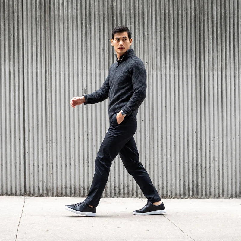 Model wearing The Low Top Onyx with dark dress pants and 3/4 zip sweater