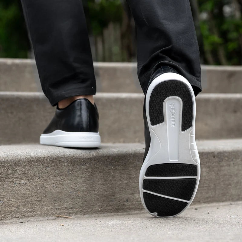 Model wearing The Low-Top Onyx paired with dark pants showing outsole