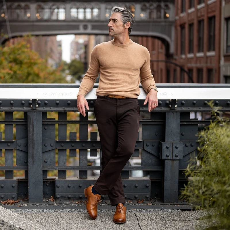 model wearing The Regent in Honey tan full-grain leather with dark dress pants and light brown sweater